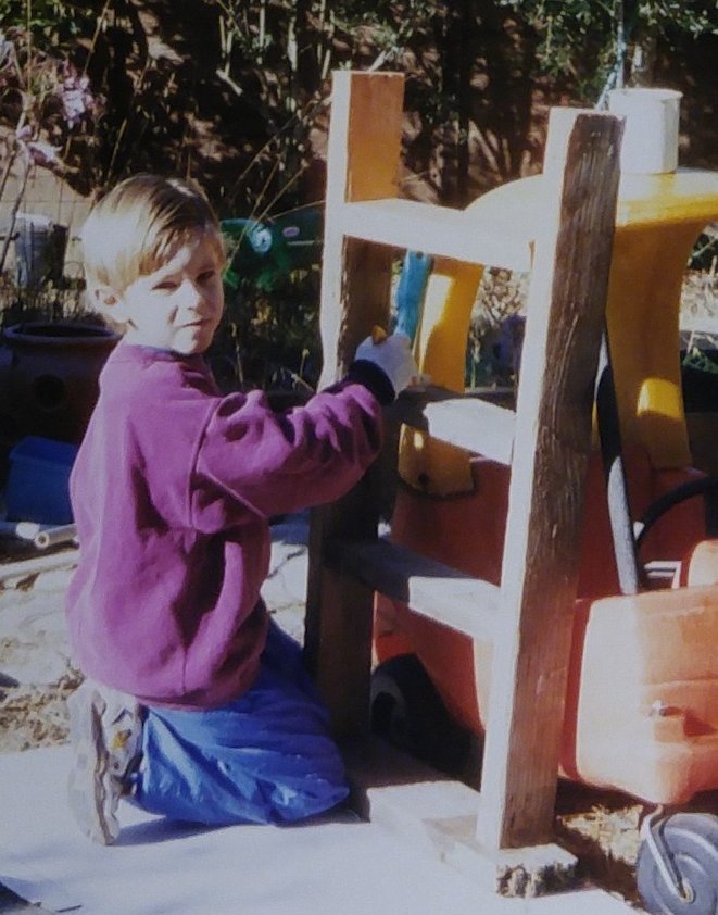 Image of Roger building a shelf at age 5.
