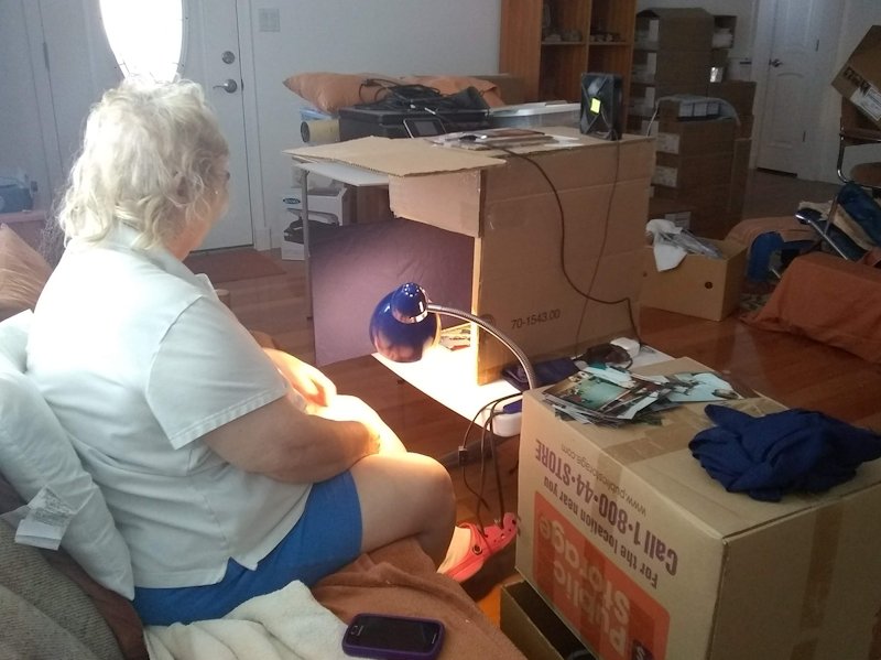 Roger’s Mother using his picture digitization device to digitize printed pictures.